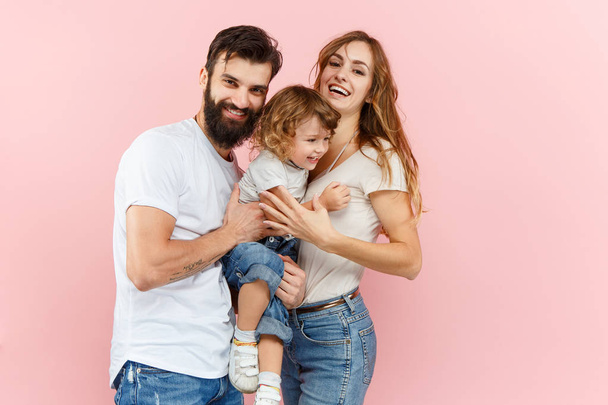 A happy family on pink background - Fotoğraf, Görsel