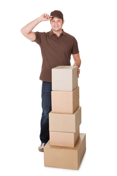 Portrait of delivery man with stack of boxes - Photo, Image
