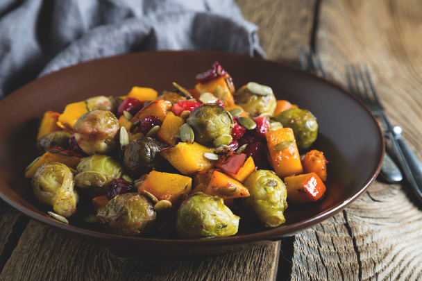 Warm Salad with Baked Pumpkin, Brussels Sprouts and Cranberries - Фото, изображение