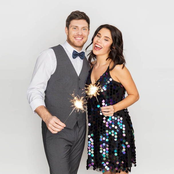 happy couple with sparklers at party - Zdjęcie, obraz