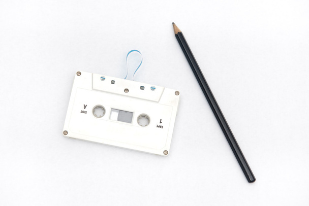 A pencil and an audio cassette tape - Photo, Image
