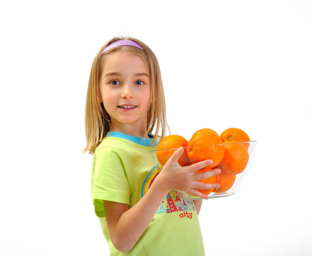 Little girl with oranges isolated on white - Foto, Imagem
