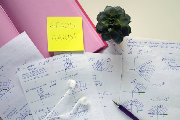 Education background. Studying desk. Notebook, headphones, pen, succulent and papers with math on the white table. Inscription "study hard". - Fotoğraf, Görsel