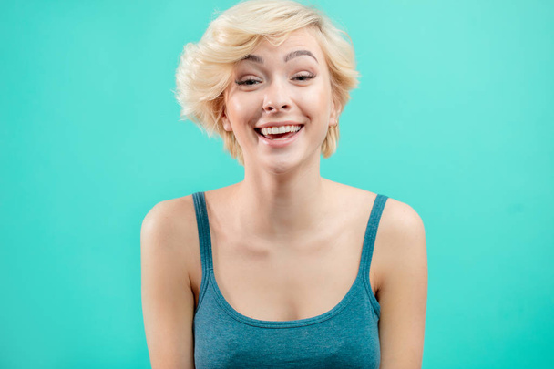 excited attractive fair-haired girl rejoycing at funny jokes - Fotoğraf, Görsel