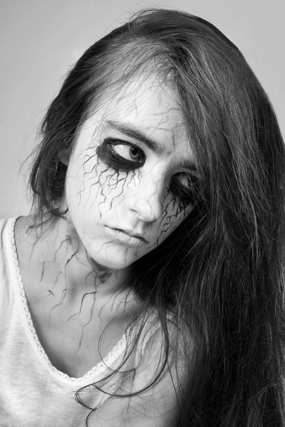 Halloween. Portrait sad girl zombie with black veins on her face. concept of halloween and day of the dead. - Photo, Image