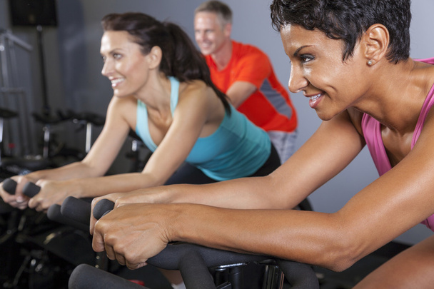 African American Woman Spinning Exercise Bike at Gym - Photo, Image