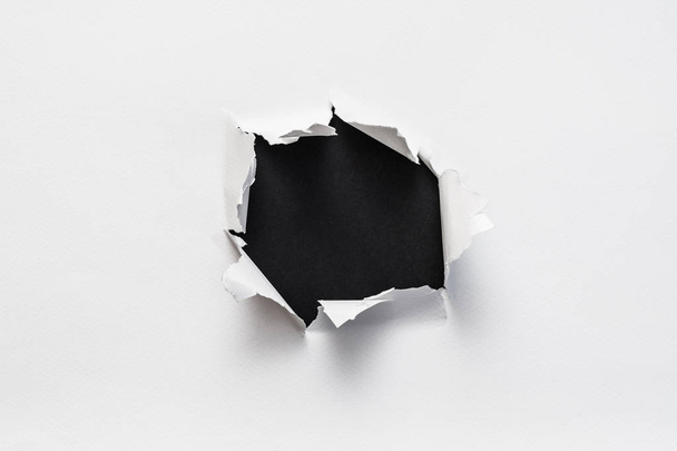 ripped torn white paper empty black space - Foto, Imagen