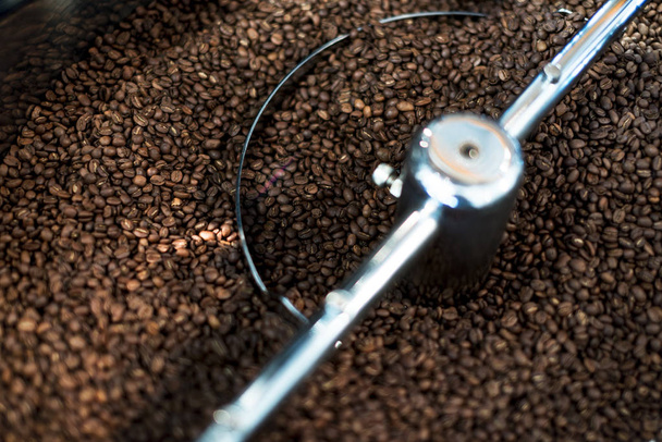 Coffee bean roasting machine. Beans are mixing close up shot. - Foto, immagini