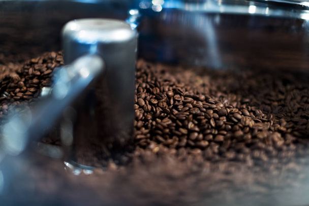 Coffee bean roasting machine. Beans are mixing close up shot. - Фото, изображение