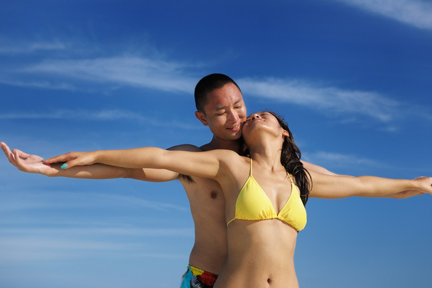 happy young couple enjoying summer on beach - Фото, зображення