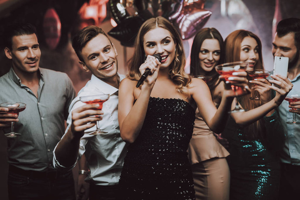 Selfie. Solo. Friends at Karaoke Club. Karaoke Club. Celebration.Sing and Drink. Black Dress. Nightclub. Have Fun. Background. Cheerful. Smiling Girl. Singing Songs. Handsome Men. Beautiful Girls. - Fotó, kép