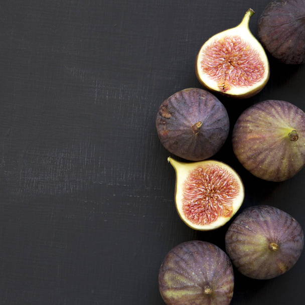 Fresh figs on dark surface, overhead view. From above, top view. Space for text. - Photo, Image