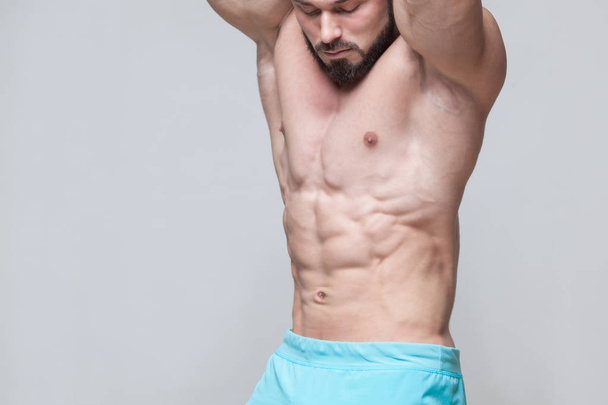 Strong Athletic Man Fitness Model Torso showing six pack abs. isolated on grey background with copyspace - Zdjęcie, obraz