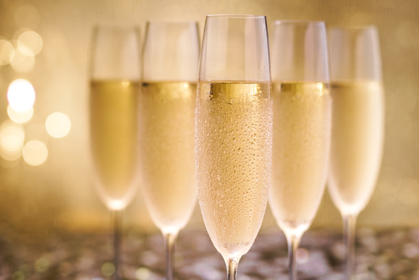 Champagne on gold background.Selective focus. - Фото, зображення