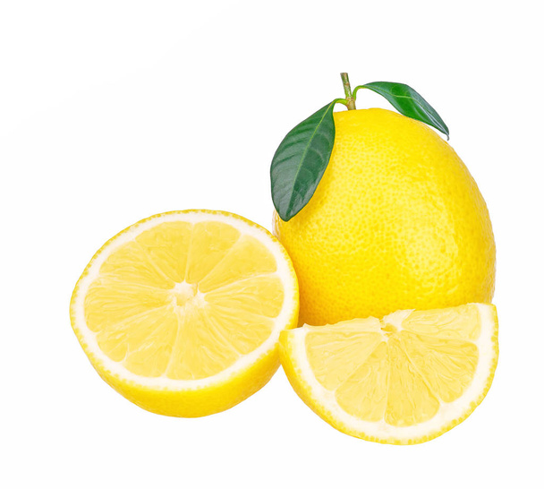 Ripe half of yellow lemon citrus fruit with green leaves isolated on white background - Valokuva, kuva