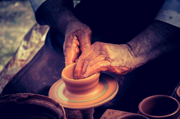 Potter`s hands shaping up the clay of the pot - Fotoğraf, Görsel