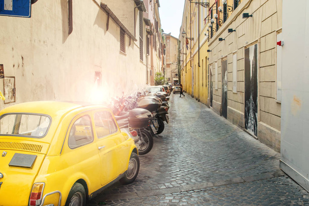 Rome, Italy - May 22, 2017: Old yellow car Fiat 600 parked in a street of Rome, Italy - Photo, Image