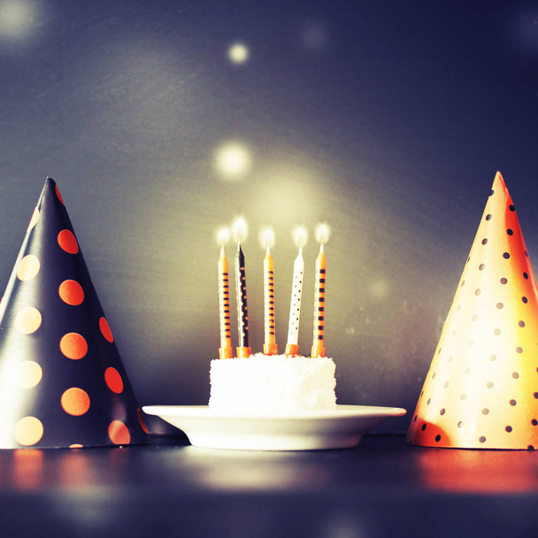Birthday cake with candles and cone hats in vintage color, copy space - Fotó, kép