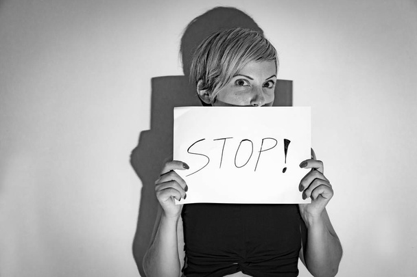 woman holds a baner for stoping the violence against women - 写真・画像