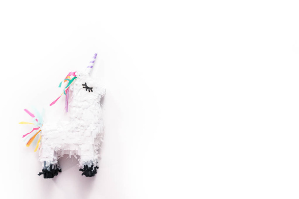 Pequeña piñata unicornio sobre fondo blanco
. - Foto, imagen