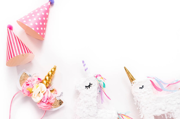 Party hats and unicorn headband on a white background. - Photo, image