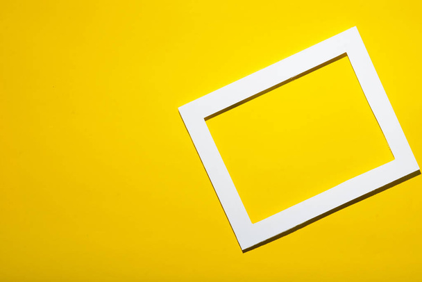 Empty frame on yellow pastel wall with copy space. Minimal concept. - Zdjęcie, obraz