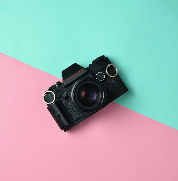 Retro camera on a colored paper background, flat lay, top view, minimalistic trend - Photo, Image
