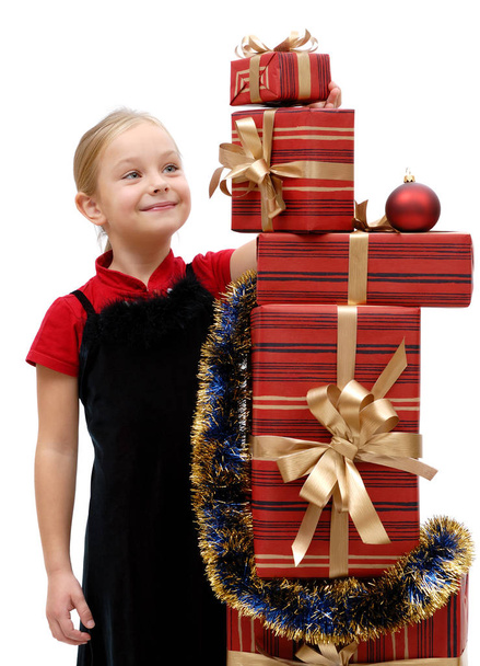 Cute little girl with Christmas gifts on a white background, isolated - Foto, Bild