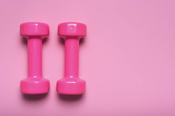 Pair of pink dumbbell on pink color - 写真・画像
