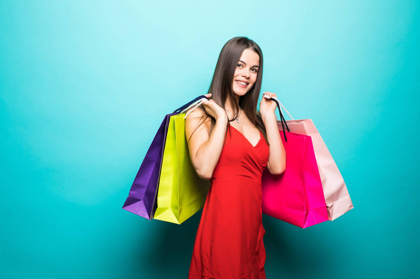 Woman with shopping bags on light background - Foto, imagen