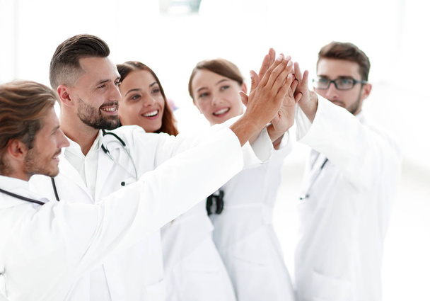 group of doctors giving each other a high five. - Φωτογραφία, εικόνα