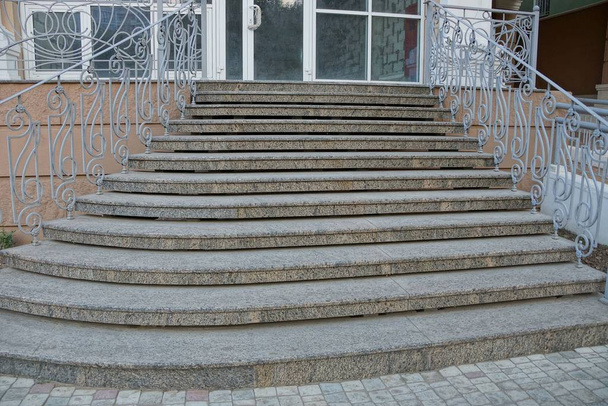 gray concrete steps and iron railings at the sidewalk near the glass wall - Photo, Image