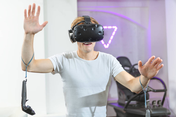 Egy fiatal, jóképű srác játszik a virtuális valóság játékok - Fotó, kép