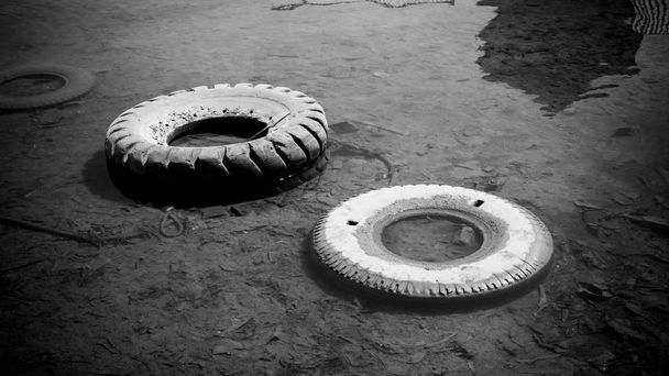 abandoned tire on the water sea or lake pond with black and white style color in indonesia - Photo, Image