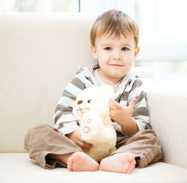 Portrait of a little boy with his teddy bear - Fotó, kép