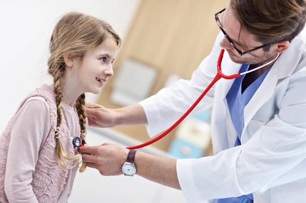 Little girl in clinic having a checkup with pediatrician - Photo, Image