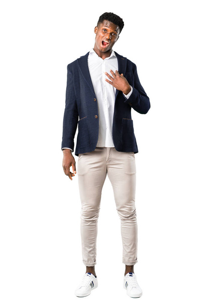 Full body of Handsome african american man wearing a jacket surprised and shocked while looking right. Expressive facial emotion on white background - Фото, изображение