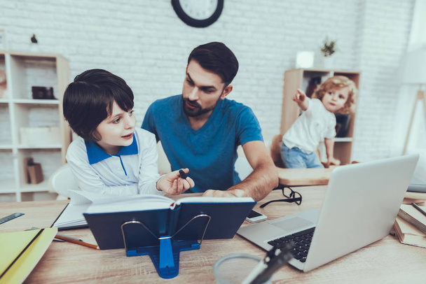 Home Time. Father Two Boys. Homework. Upbringing. Looks After Children. Spends Time. Happy Together. Leisure Time. Smiling Kids. Father. Man. Baby with Bright Hair. Works at Home. Laptop. - Foto, imagen