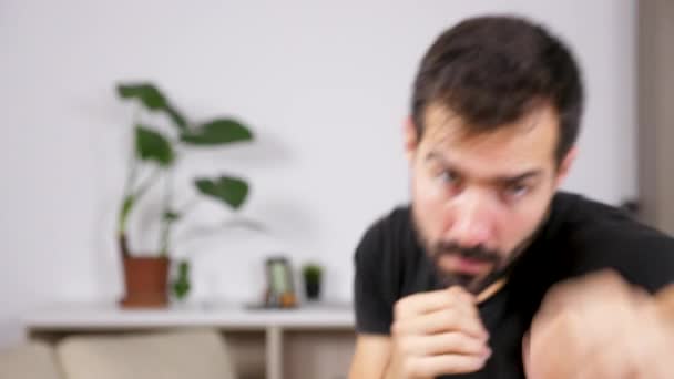Unfocused man practicing box at home - Video, Çekim