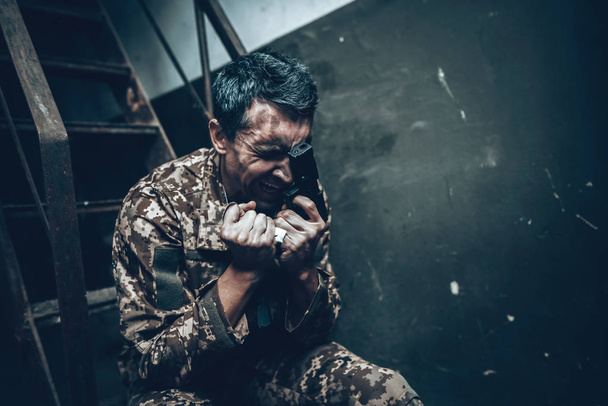 Man Is Sitting In War Shelter With Shotgun. Camouflage Uniform. Military Actions. War Hideaway Concept. Occupation Problem. Depressed Soldier. Disappointed Hero. Posttraumatic Syndrome. - Foto, Bild
