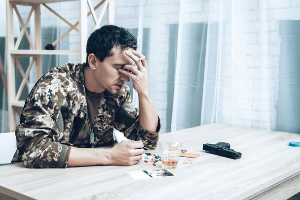 A Man In Camouflage At Home With Cigarette. Depression After War.. Depression After War Concept. Sad Homecoming. Returning From Army. Posttraumatic Disorder. Painful Memories. Photo From War. - Photo, image