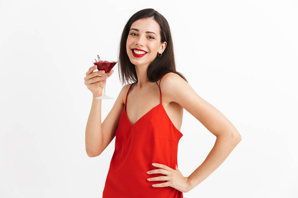 Photo of young happy excited woman posing isolated drinking cocktail. - Photo, Image