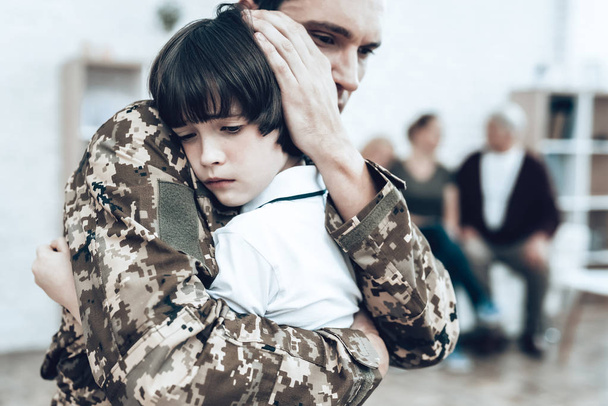 A Man Goes To Military Service. Saying Goodbye. Leaving To Army. Farewell With Family. Camouflage Uniform. Son Hanging. Feelings Showing. Guard Of Peace. Patriotic Decision. Soldier Emotion. - Foto, afbeelding