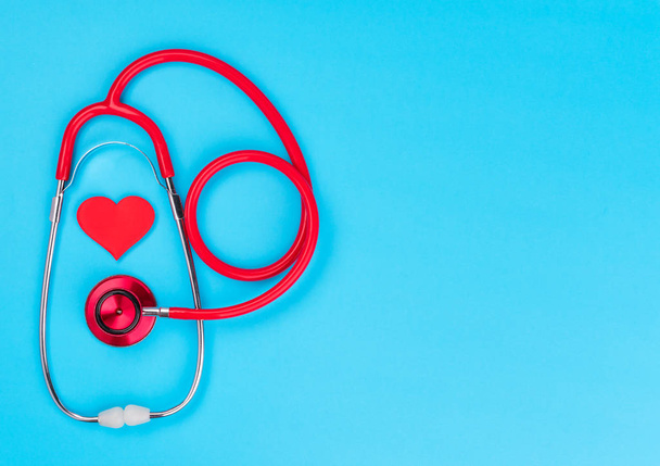 Medical equipment: red stethoscope on blue background.World health day.Medicine concept. - Valokuva, kuva