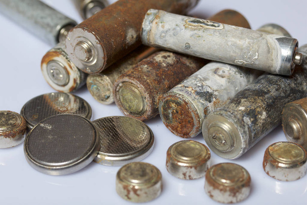 The fulfilled batteries of the different size covered with corrosion. Recycling. - Foto, Imagen