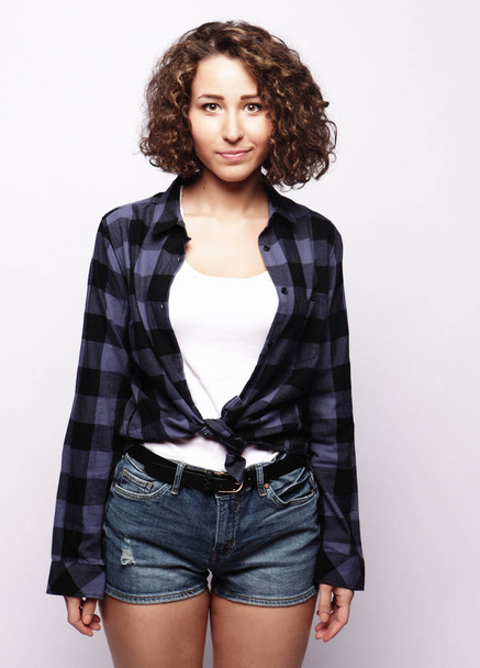 lifestyle and people concept:Young happy woman with curly hair - Φωτογραφία, εικόνα