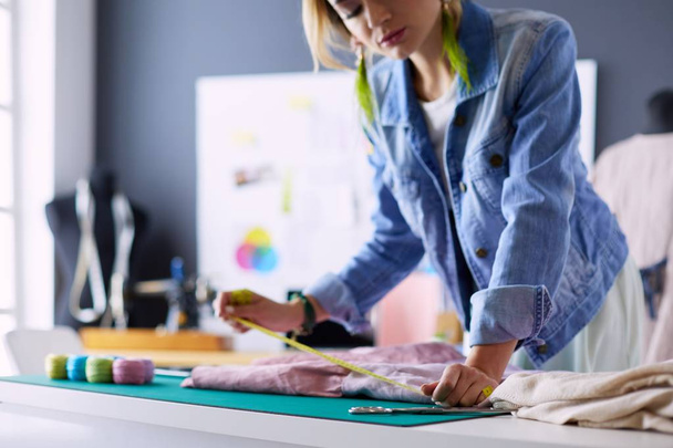 Fashion designer woman working on her designs in the studio - Foto, Bild