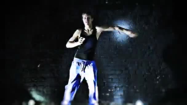 Young man dancing on wall background. - Filmmaterial, Video
