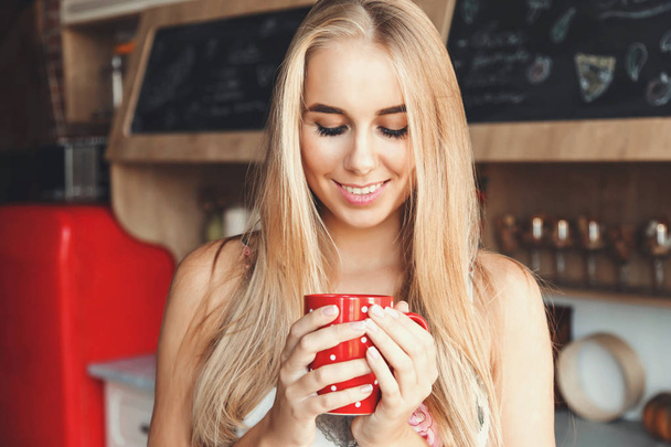 Cute Girl Drinking Coffee On The Kitchen - 写真・画像