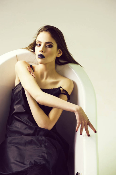 white bath tub and beautiful young woman with black lips - 写真・画像
